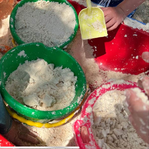 Buckets full of kinetic sand.